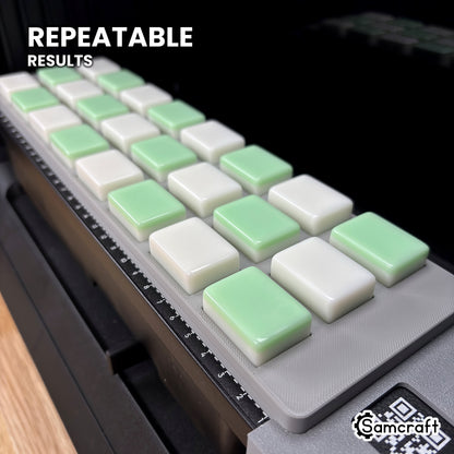 Angled view of white and green mahjong tiles lined up in matching pockets of the Samcraft eufyMake E1 jig, every tile in the same position.