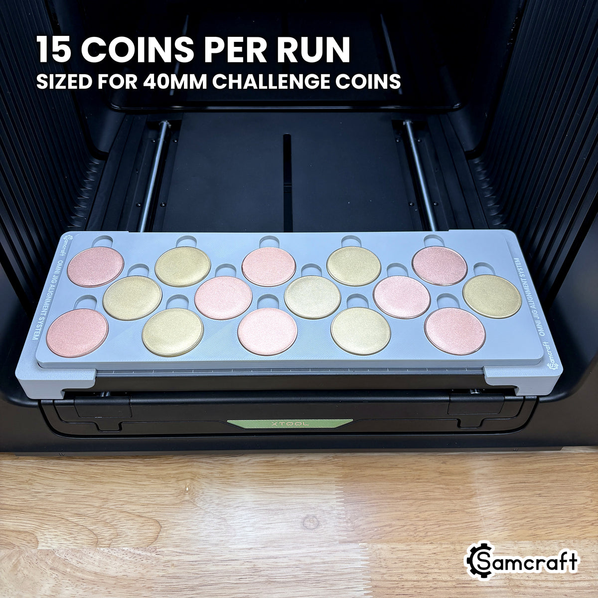 Samcraft 40mm metal coin jig loaded with fifteen blank challenge coins in three staggered rows of five, a full run in a single pass on the xTool Omni.