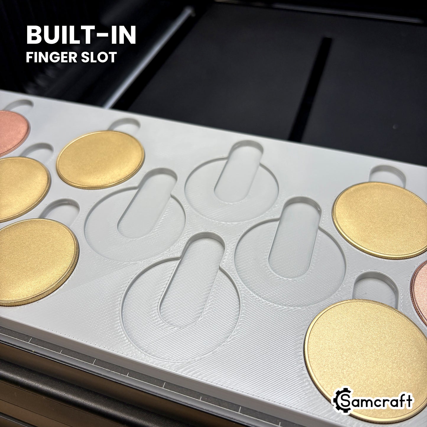 Close-up of the Samcraft 40mm coin jig showing the built-in finger slot above each empty pocket, so a coin lifts straight out without prying.