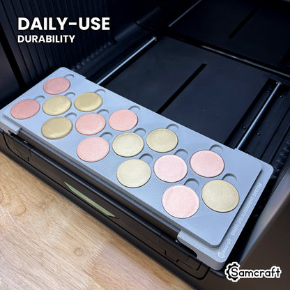 Samcraft 40mm metal coin jig in high-temperature rated plastic holding blank rose gold and gold coins on the xTool Omni bed, built for daily-use durability.