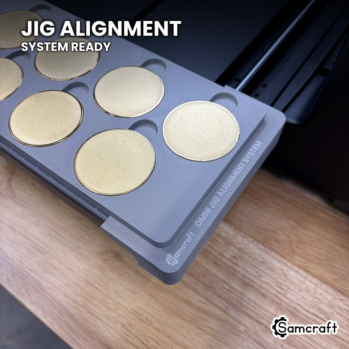 Close-up of the Samcraft 50mm metal coin jig seated on the Omni Jig Alignment System, the alignment system lettering visible along the edge.