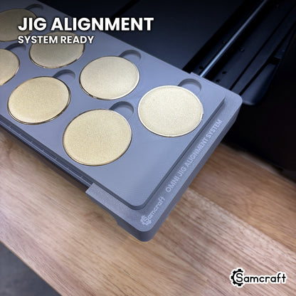 Close-up of the Samcraft 50mm metal coin jig seated on the Omni Jig Alignment System, the alignment system lettering visible along the edge.