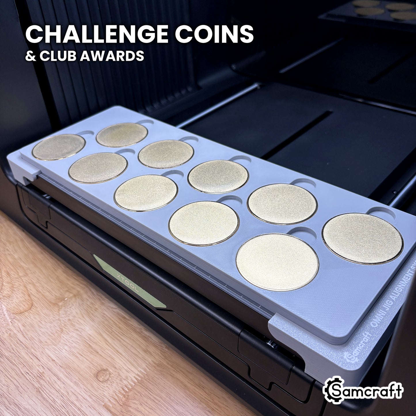 Samcraft xTool Omni 50mm metal coin jig filled with ten blank challenge coins, ready for challenge coin runs and club awards.