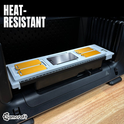 Heat-resistant Samcraft Luggage Tag Jig with gold and silver metal tags arranged in a gray tray on the eufyMake E1 UV printer print bed.