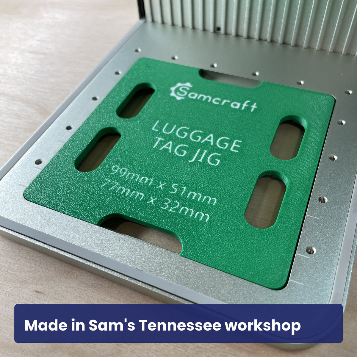 Samcraft luggage tag jig in the laser bed showing its back markings: the Samcraft logo and the 99 by 51 and 77 by 32 millimetre sizes.