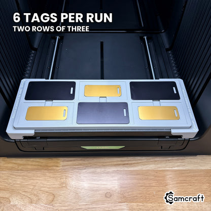 Samcraft metal luggage tag jig for the xTool Omni holding six tags, a full tray printed in one job.