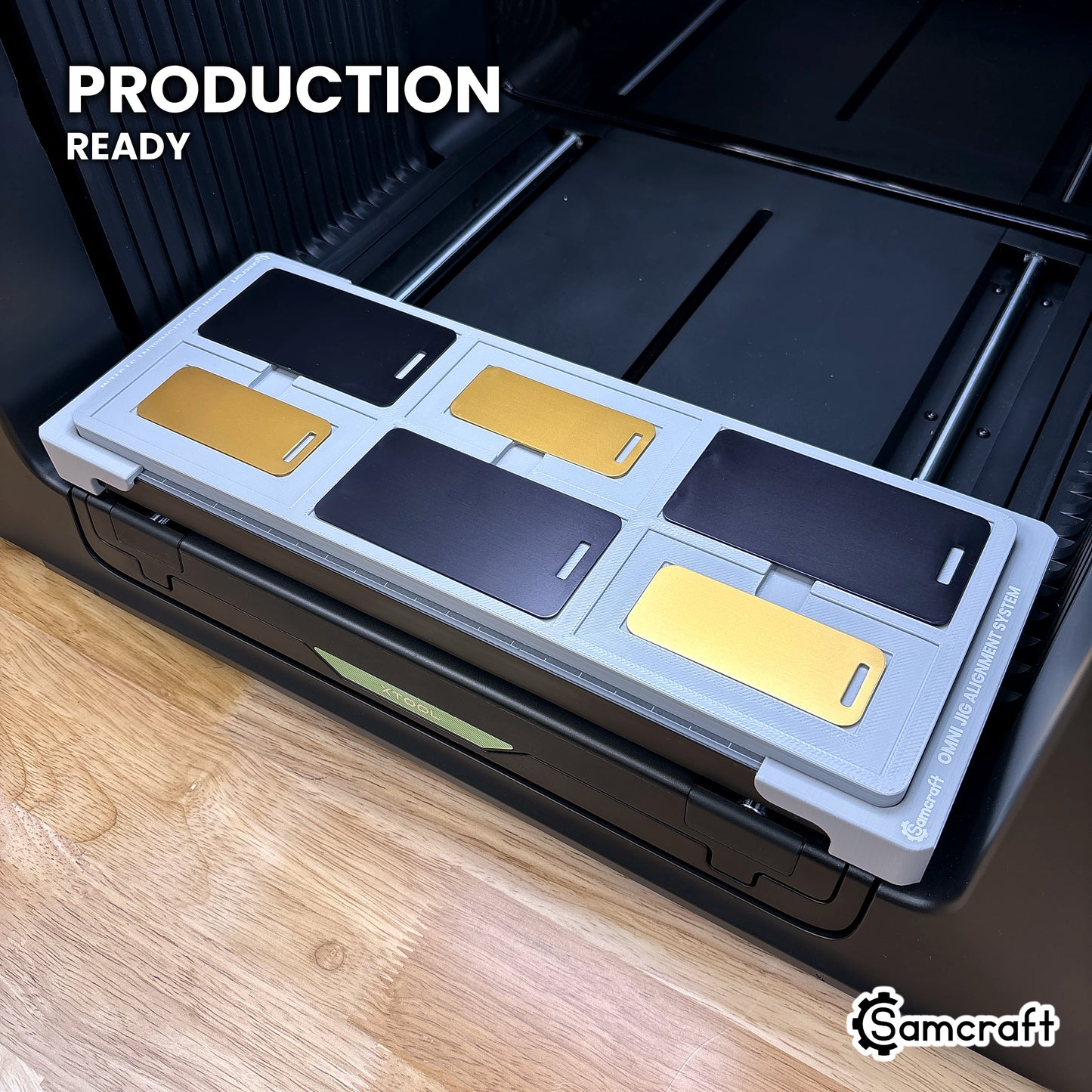 Samcraft metal luggage tag jig loaded with six tags on the xTool Omni UV printer bed, set up for production runs.