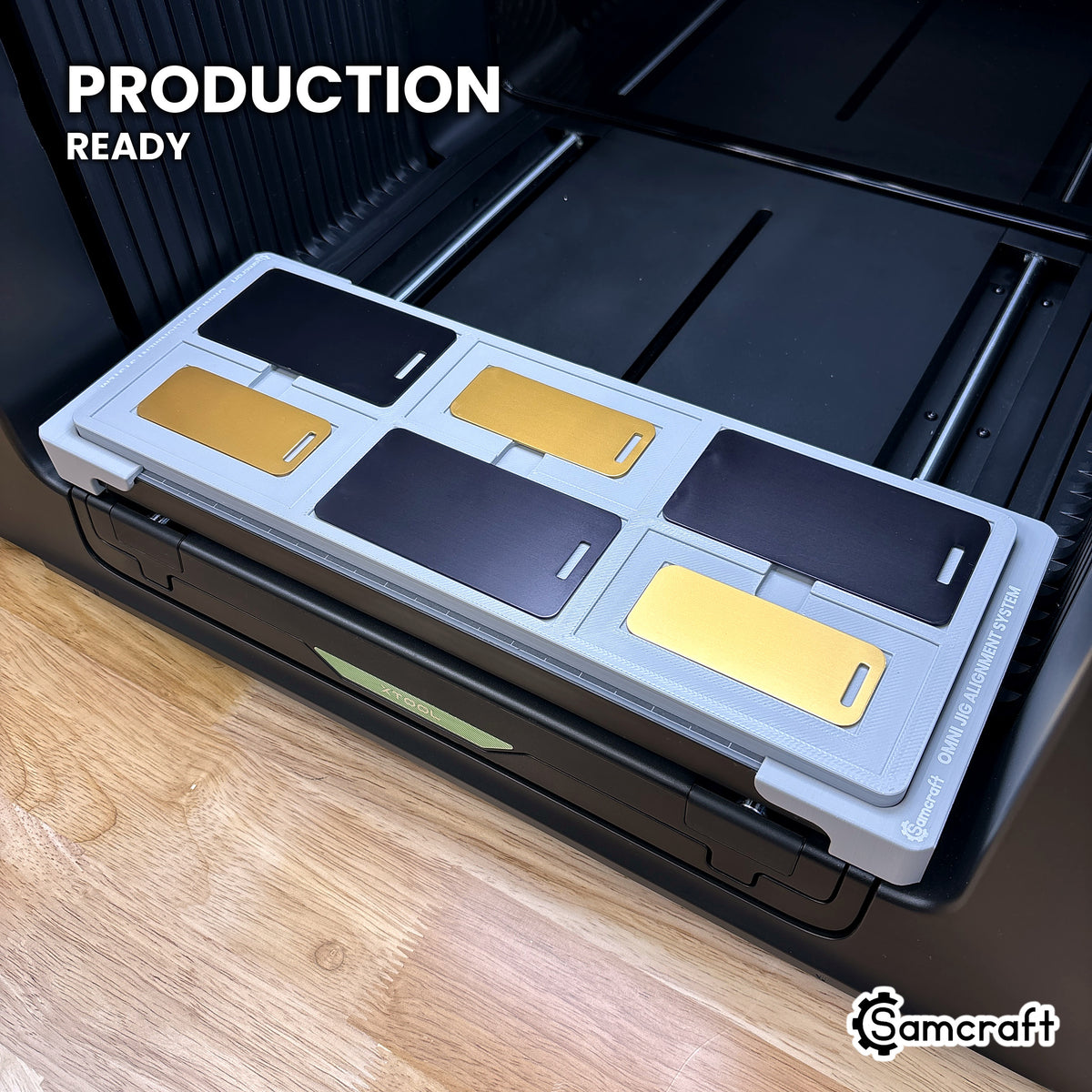 Samcraft metal luggage tag jig loaded with six tags on the xTool Omni UV printer bed, set up for production runs.
