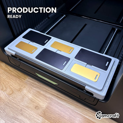Samcraft metal luggage tag jig loaded with six tags on the xTool Omni UV printer bed, set up for production runs.