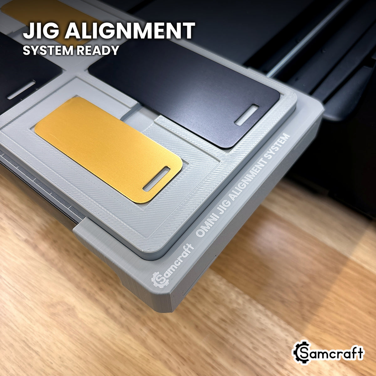 Samcraft metal luggage tag jig seated on the optional Samcraft Omni Jig Alignment System, the alignment system lettering visible along the edge.
