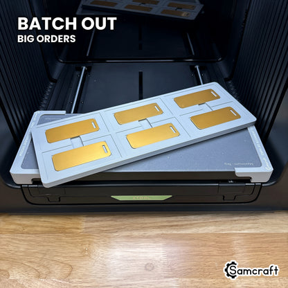 Samcraft xTool Omni metal luggage tag jig filled with printed tags, ready for travel, team and gift batch orders.