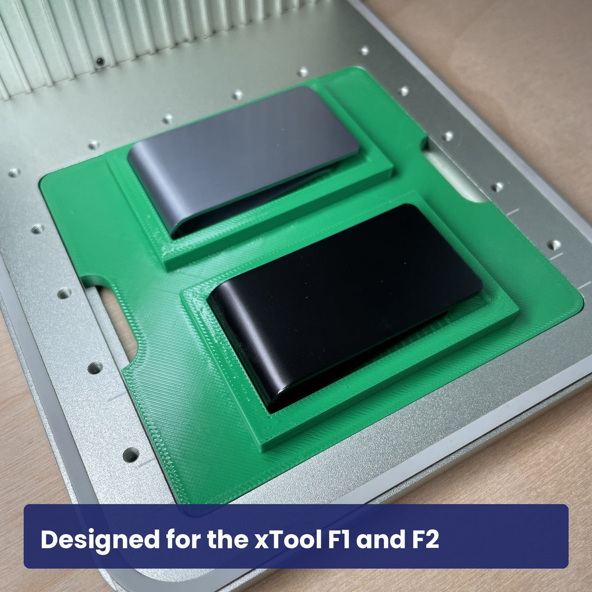 Samcraft money clip jig seated in the xTool F1 base plate with a metal money clip in the recess.