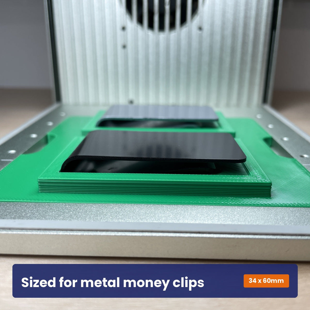 Samcraft metal money clip jig holding a clip, showing the 34 by 60 millimetre size it accepts.