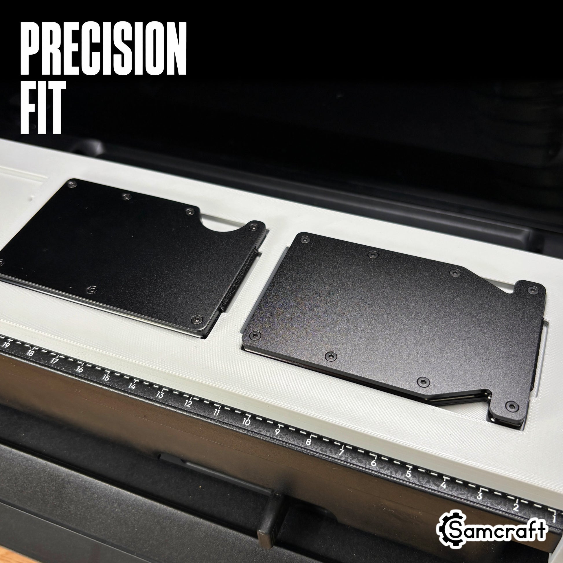 Close-up of two black metal wallets seated flush in the precision pockets of the Samcraft Metal Wallet Jig