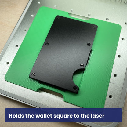 Close view of the Samcraft metal wallet jig holding a black metal wallet in the laser bed.