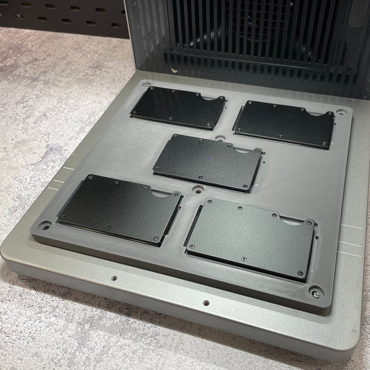 Samcraft metal wallet jig on the xTool F2 Ultra bed, holding black metal card wallets.