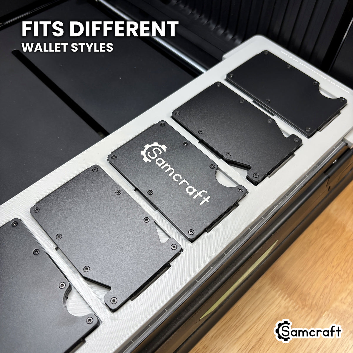 Different metal wallet styles seated in the same Samcraft xTool Omni pockets, including plain backs and thumb-slide cutout designs.