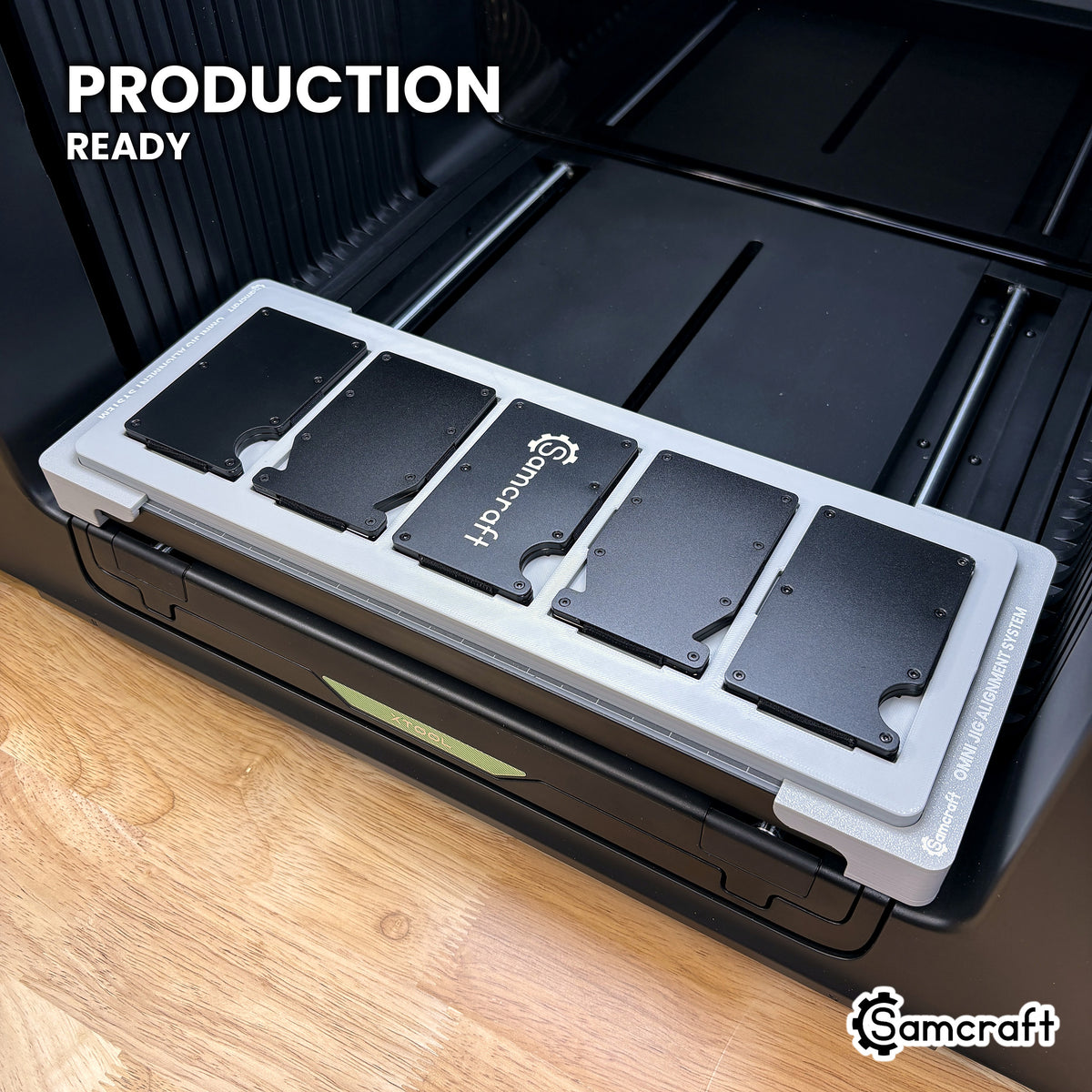 Samcraft wallet jig loaded with five metal wallets on the xTool Omni UV printer bed, set up for production runs.
