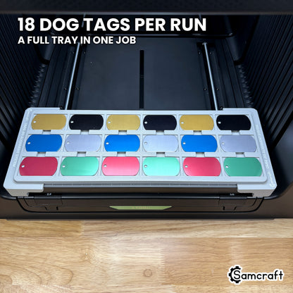 Top view of the Samcraft military dog tag jig for the xTool Omni with all eighteen pockets filled, six columns of three, a full tray in one job.