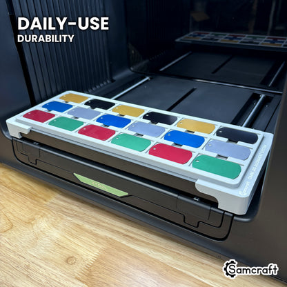 Samcraft military dog tag jig in high-temperature rated plastic holding eighteen tags on the xTool Omni bed, built for daily use.