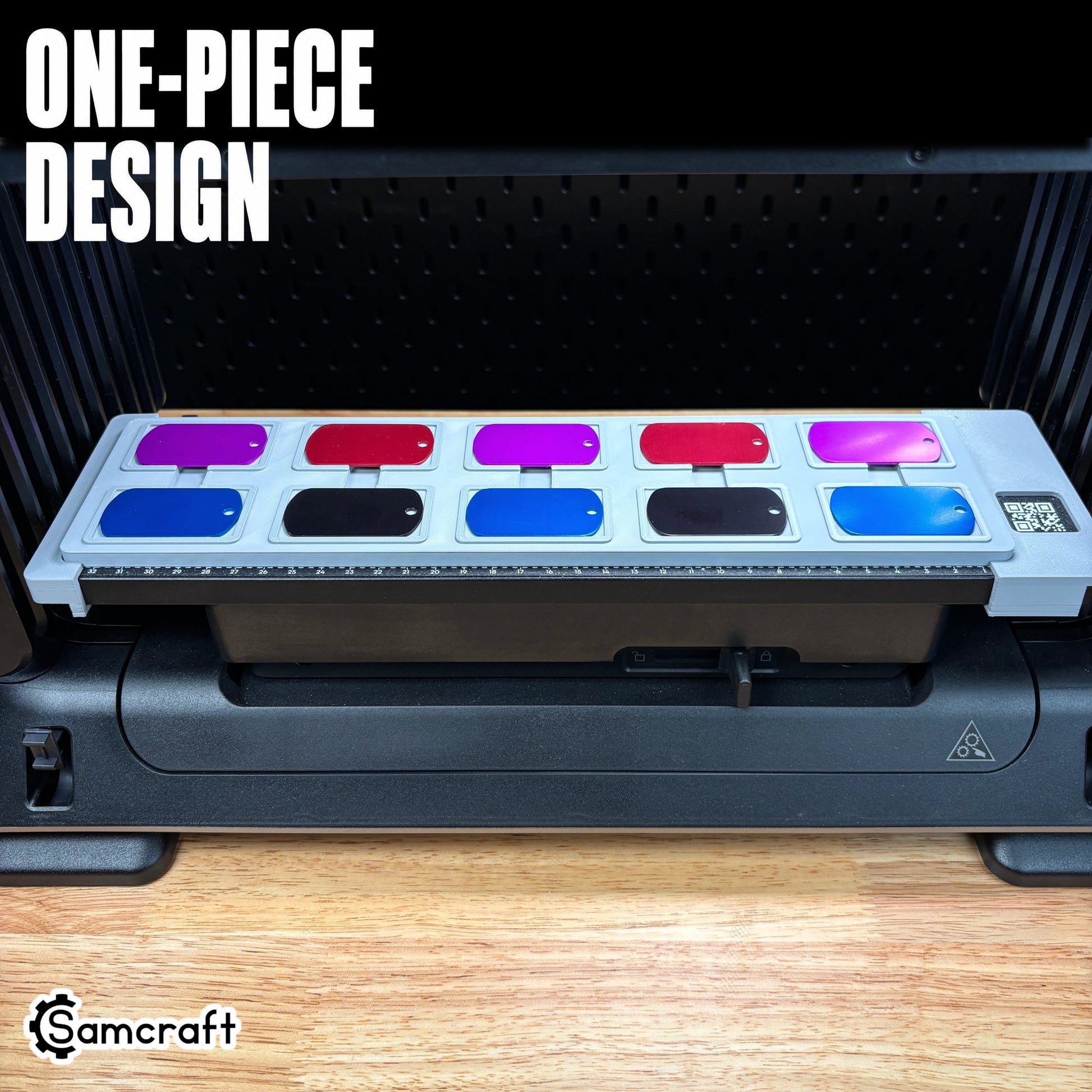 Front view of the one-piece Samcraft Military Dog Tag Jig with two rows of red, purple, blue, and black dog tags arranged on the eufyMake E1 UV printer.