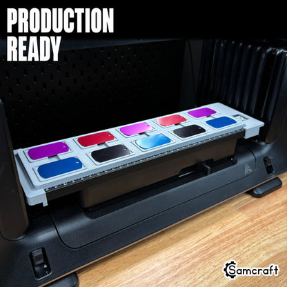Full view of the Samcraft Military Dog Tag Jig loaded with ten colorful anodized dog tags, mounted on the eufyMake E1 UV printer bed, labeled "Production Ready."