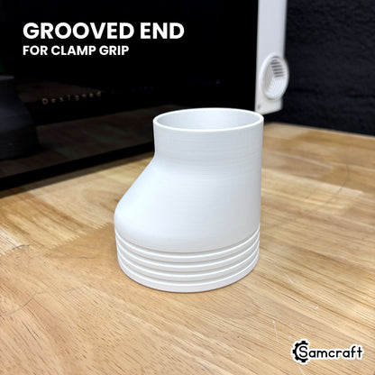 Samcraft offset exhaust adapter on a wood bench beside the xTool Omni, showing the grooved 4 inch end where the hose clamp sits.