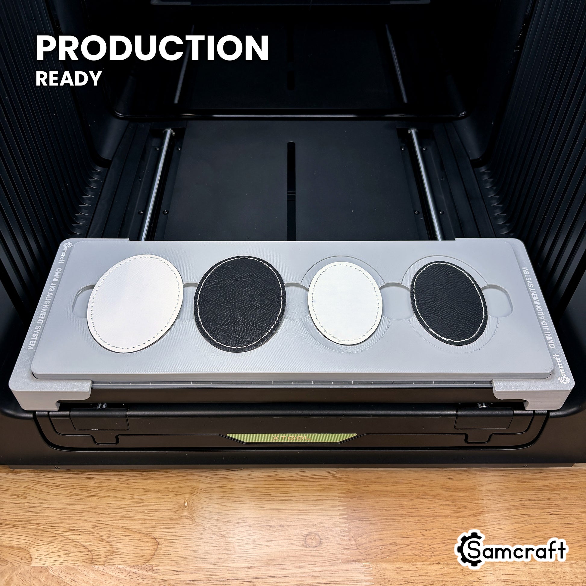 Samcraft patch jig loaded with four leatherette oval patches on the xTool Omni UV printer bed, set up for production runs.