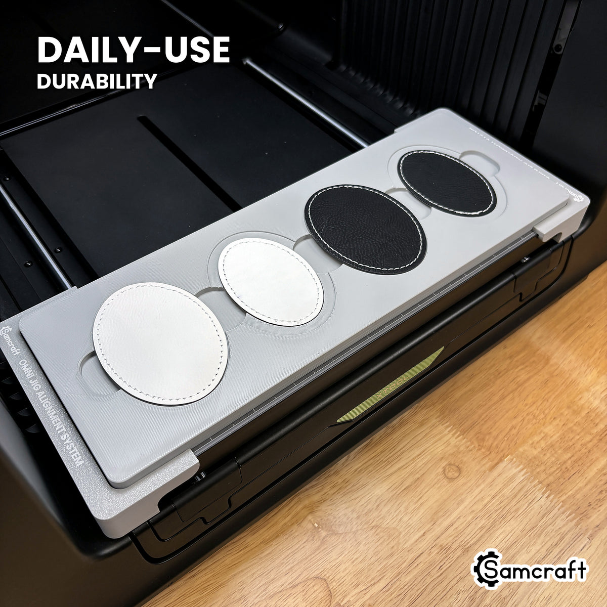 Samcraft patch jig in high-temperature rated plastic holding leatherette oval patches on the xTool Omni bed, built for daily-use durability.