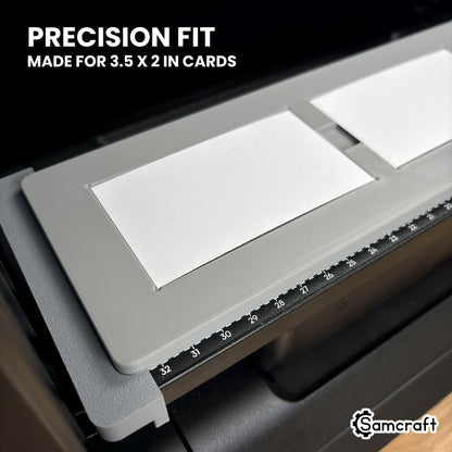Close-up of a white 3.5 x 2 inch business card sitting flush in its pocket in the Samcraft eufyMake E1 jig.