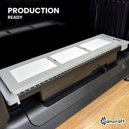 Samcraft paper business card jig loaded with three cards on the eufyMake E1 UV printer bed, set up for production runs.
