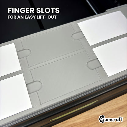 Close-up of the Samcraft xTool Omni paper business card jig with two pockets empty, showing the finger slots between the pockets for lifting cards out.