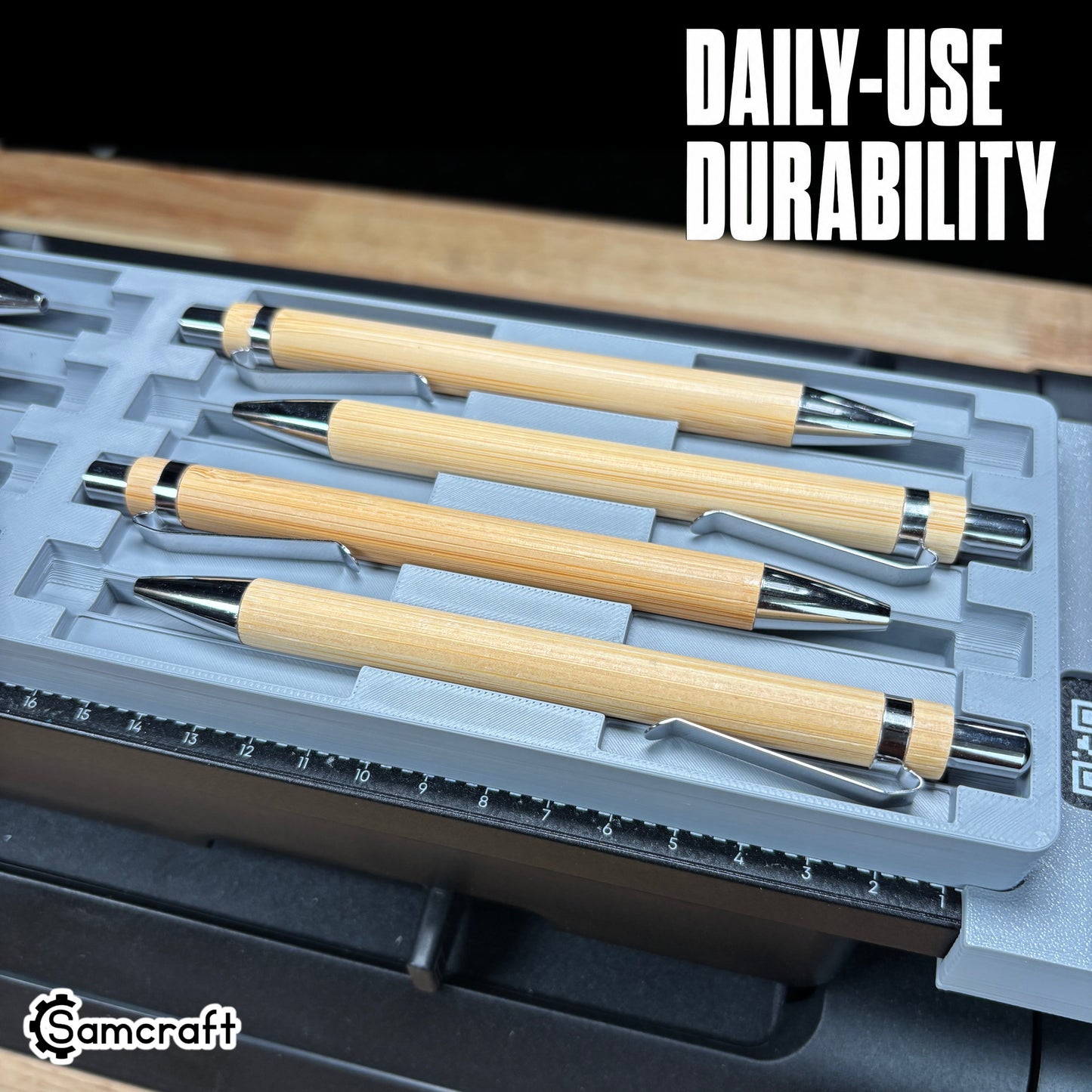 Daily-use durable Samcraft Universal Pen Jig holding bamboo pens with chrome tips in a gray tray with alignment ruler on the eufyMake E1 UV printer.