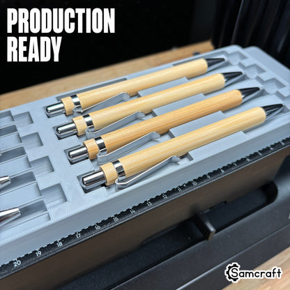 Production-ready Samcraft Universal Pen Jig holding bamboo pens with chrome accents in recessed channels on the eufyMake E1 UV printer bed.