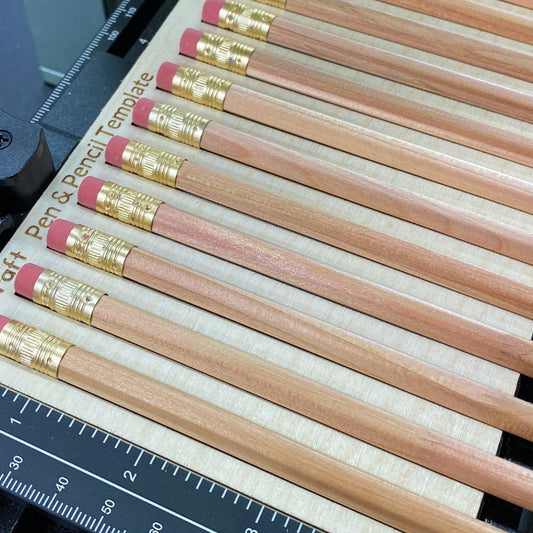 Samcraft pen and pencil template on the xTool F1 slide extension, loaded with a row of wooden pencils.