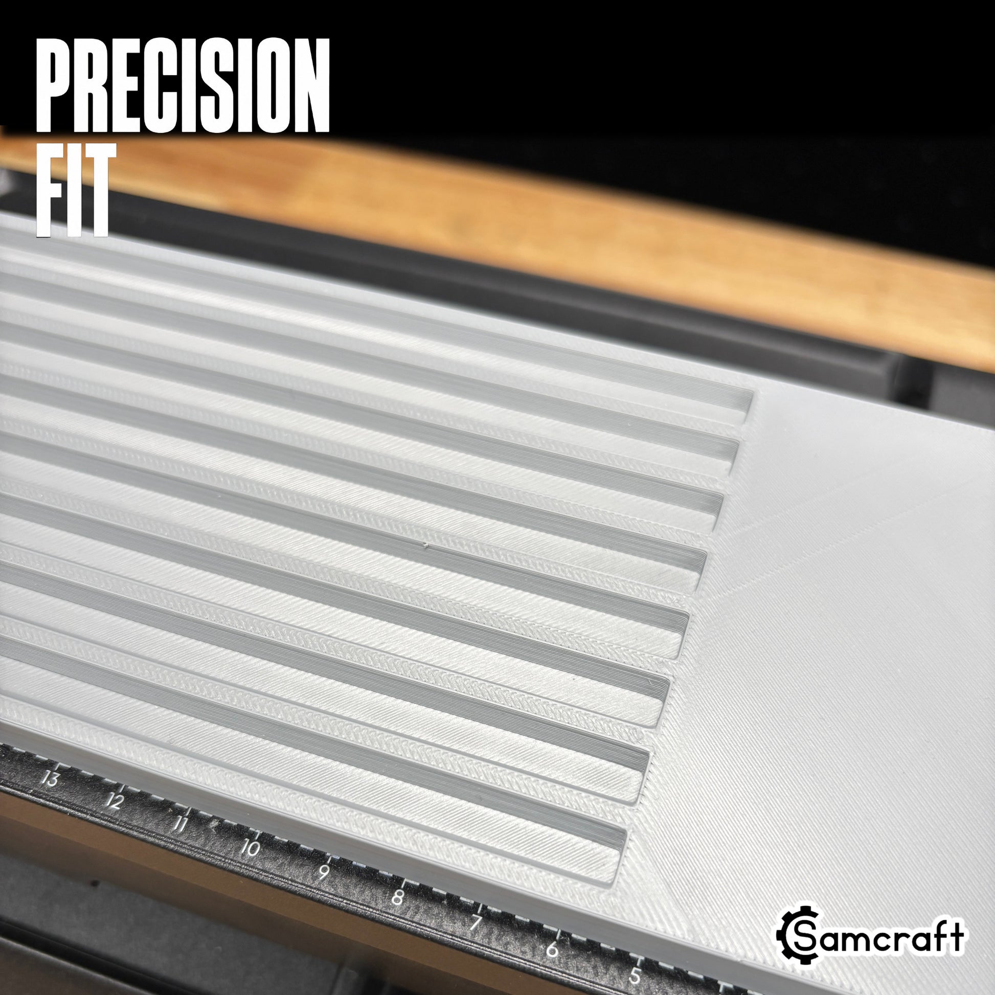 Detail of the Samcraft Pencil Jig's precision-fit parallel channels in a durable gray tray with built-in ruler, mounted on the eufyMake E1 UV printer.