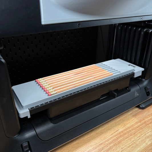 Samcraft pencil jig on the eufyMake E1 print bed, holding a row of standard wooden pencils.