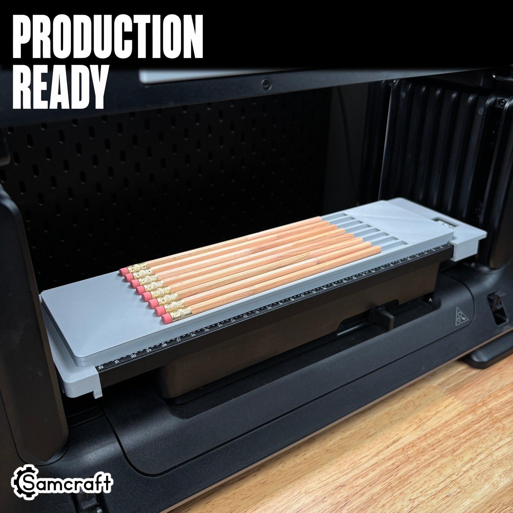 Production-ready Samcraft Pencil Jig holding a row of wooden pencils with erasers in a one-piece gray 3D-printed tray with built-in ruler on the eufyMake E1 UV printer.