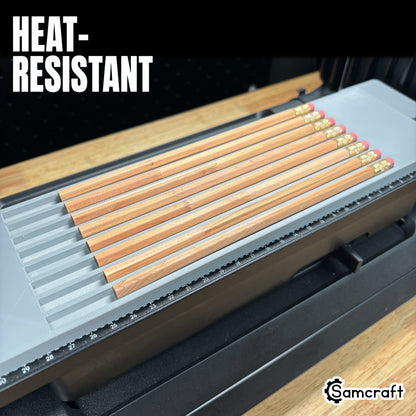 Heat-resistant Samcraft Pencil Jig holding a row of wooden pencils in parallel recessed channels with alignment ruler on the eufyMake E1 UV printer bed.
