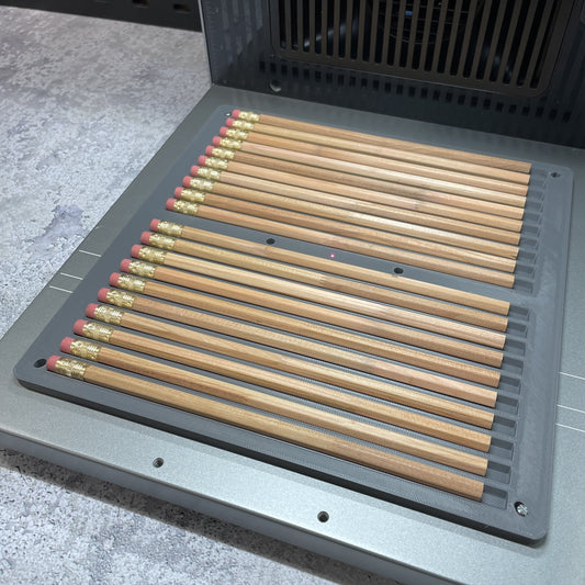 Samcraft pencil jig on the xTool F2 Ultra bed, holding a full row of wooden pencils.