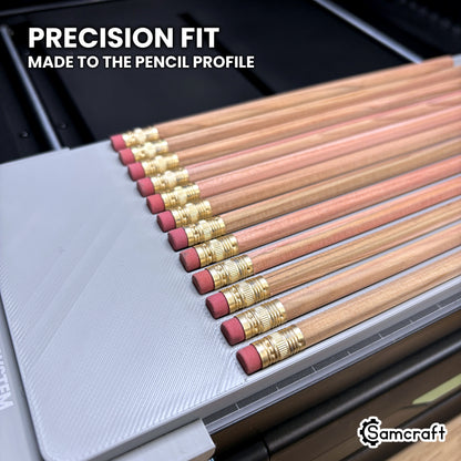 Close-up of hexagon pencils seated in the channels of the Samcraft xTool Omni jig, each channel made to cradle a six-sided barrel.