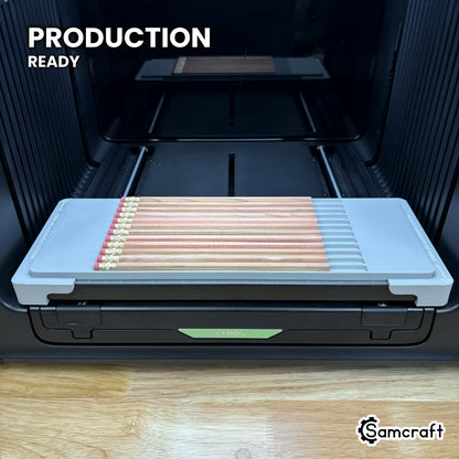 Samcraft hexagon pencil jig loaded with twelve pencils on the xTool Omni printer bed, set up for production runs.