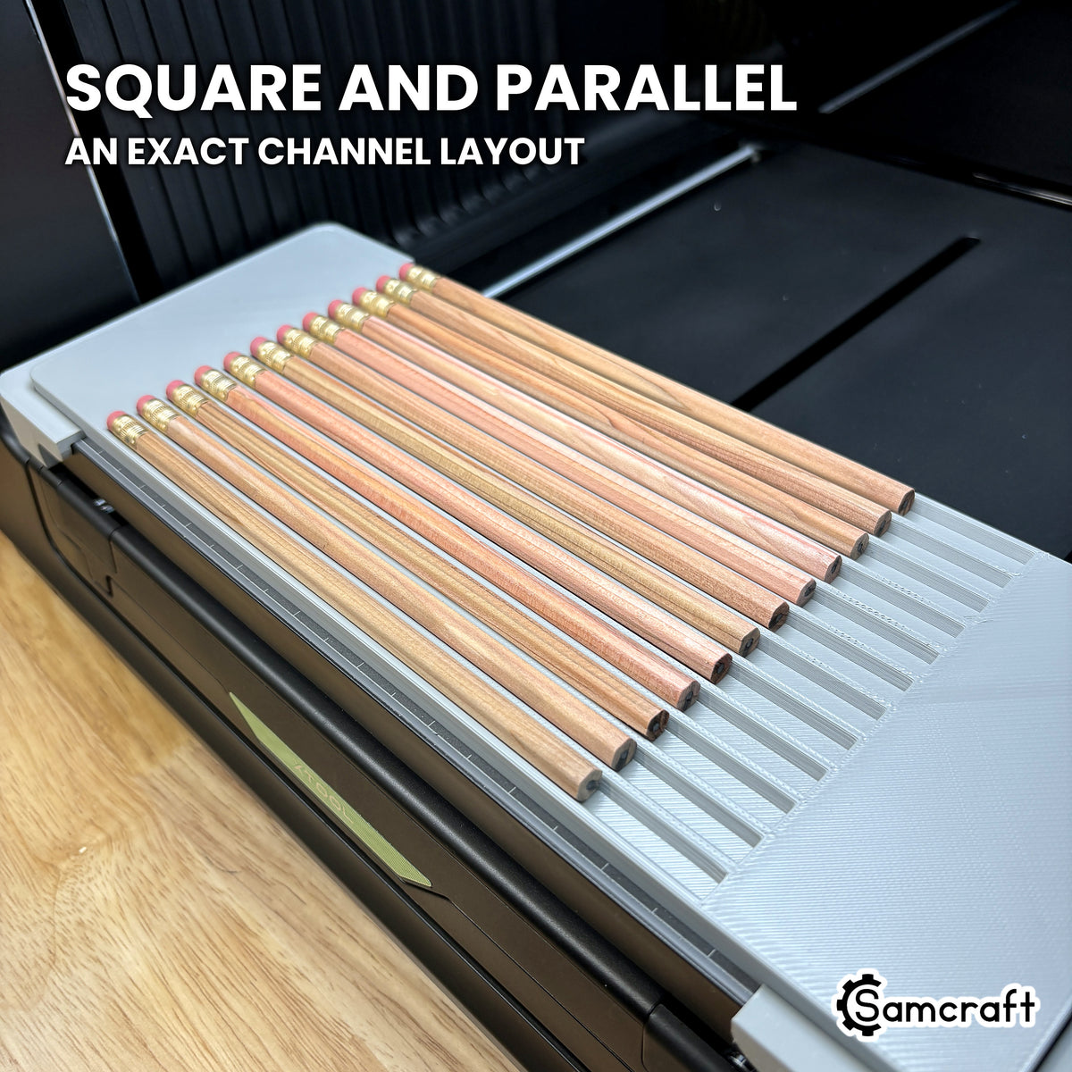 Twelve hexagon pencils lying square and parallel in the Samcraft xTool Omni jig, showing the even spacing of the channel layout.
