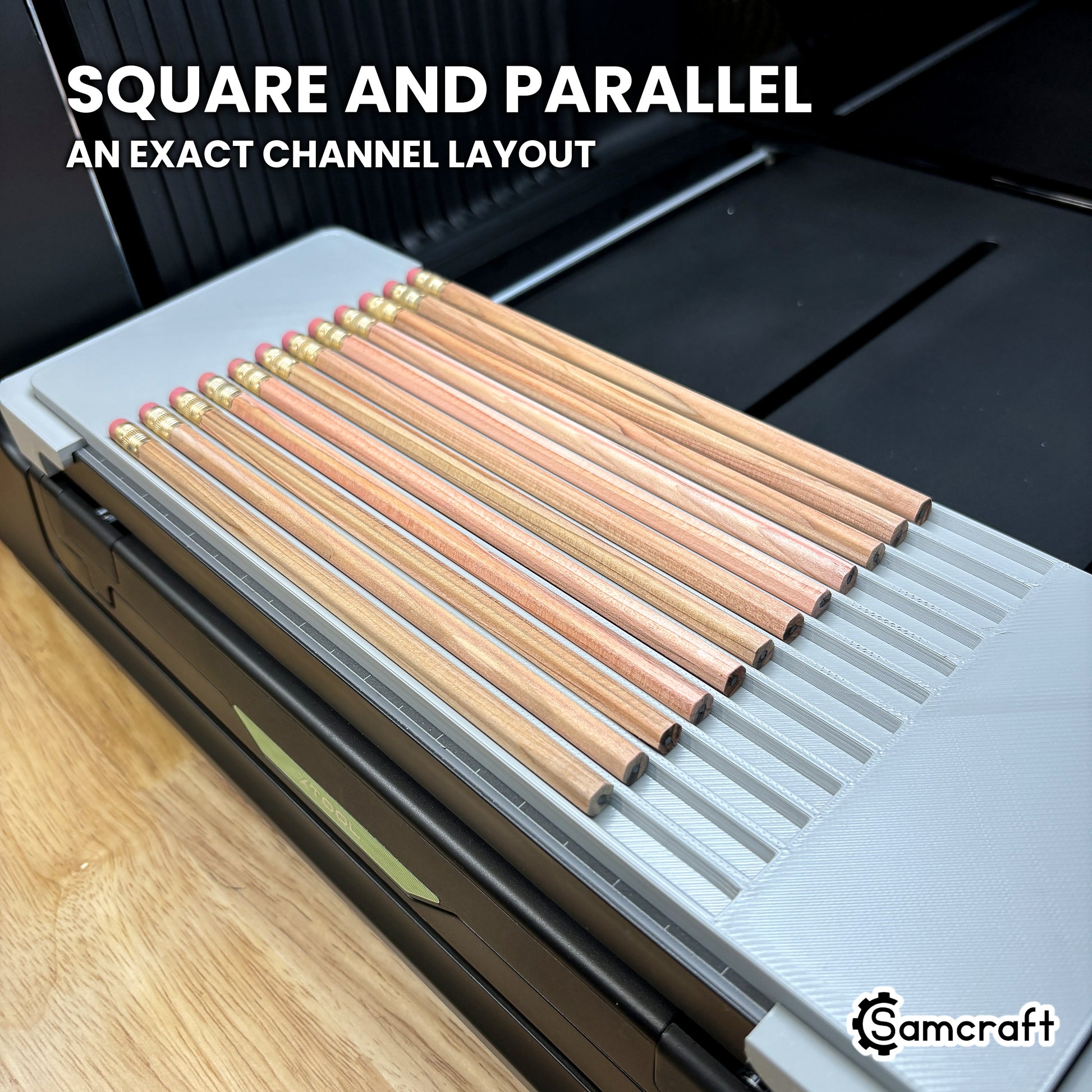 Twelve hexagon pencils lying square and parallel in the Samcraft xTool Omni jig, showing the even spacing of the channel layout.