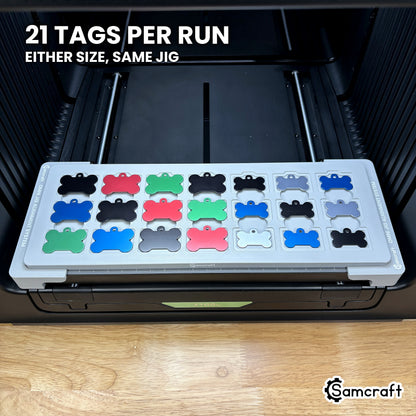 Samcraft bone pet tag jig loaded with 21 aluminum bone tags in seven columns of three, a full run in a single pass on the xTool Omni.