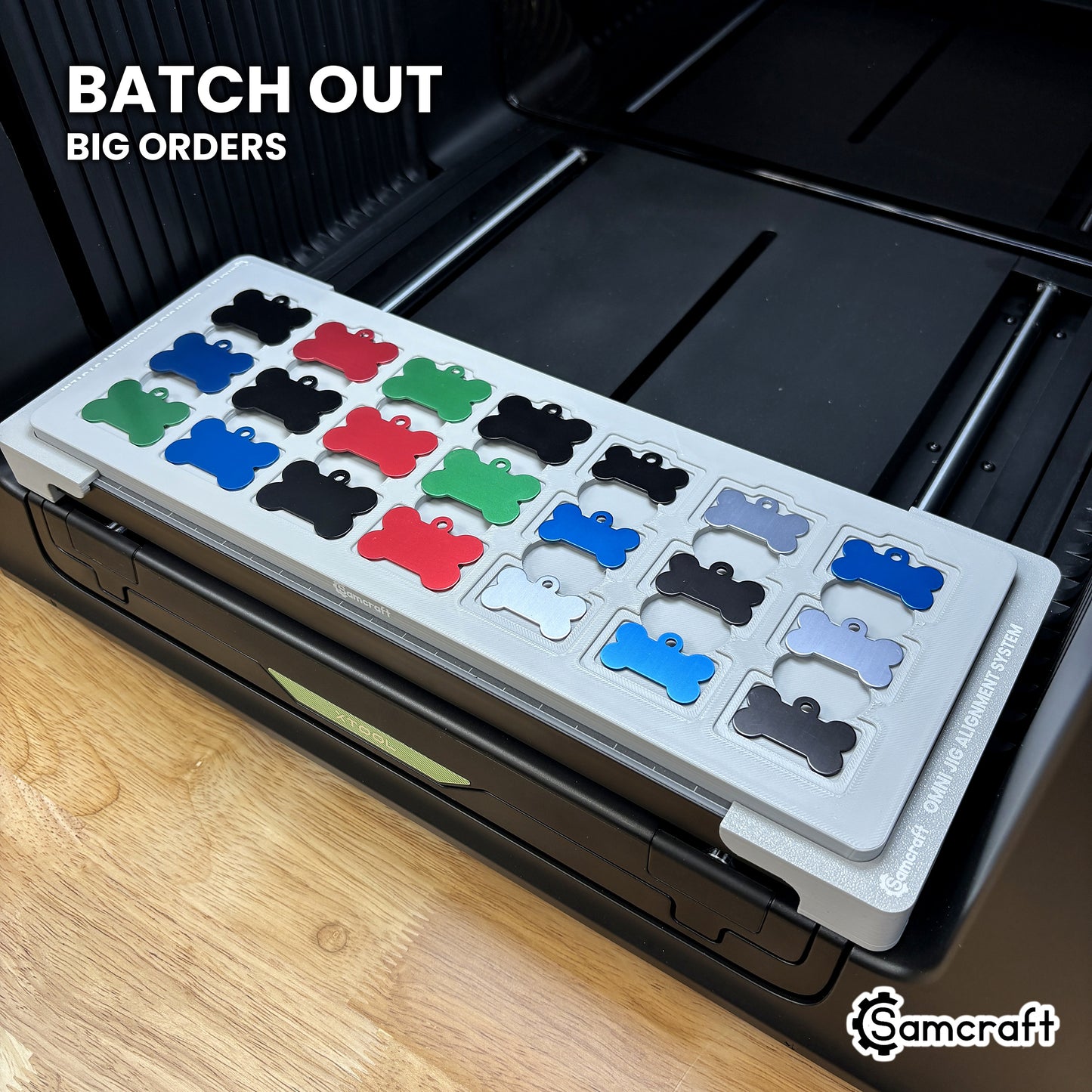 Samcraft bone pet tag jig packed with 21 colored aluminum bone tags, showing the batch volume a single run covers.