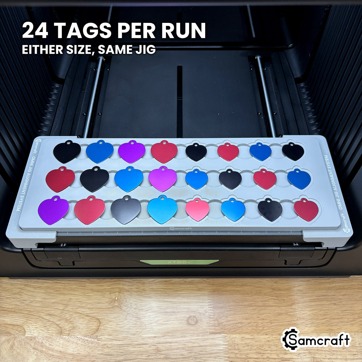 Samcraft heart pet tag jig loaded with 24 aluminum heart tags in eight columns of three, a full run in a single pass on the xTool Omni.