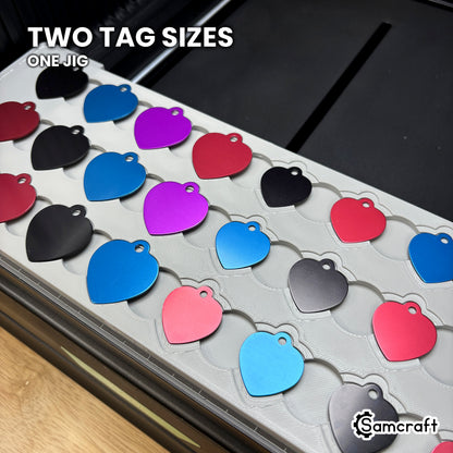 Close-up of the Samcraft heart pet tag jig showing both tag sizes seated in nested recesses, the larger tag in the outer step and the smaller in the inner recess.