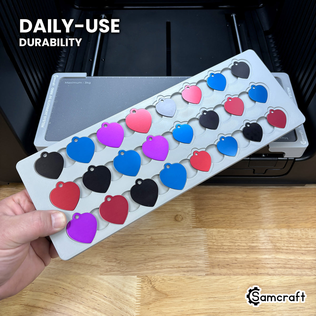 Samcraft heart pet tag jig in high-temperature rated plastic held in hand, loaded with aluminum heart tags, built for daily-use durability.