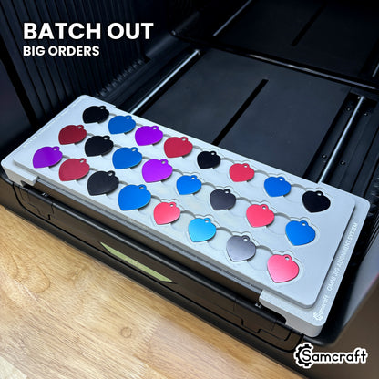 Samcraft heart pet tag jig packed with 24 colored aluminum heart tags, showing the batch volume a single run covers.